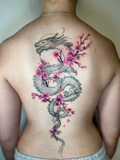 Japanese dragon with cherry blossom tattoo on full back, fine line black and grey with pink colour accents by Letchworth tattoo artist