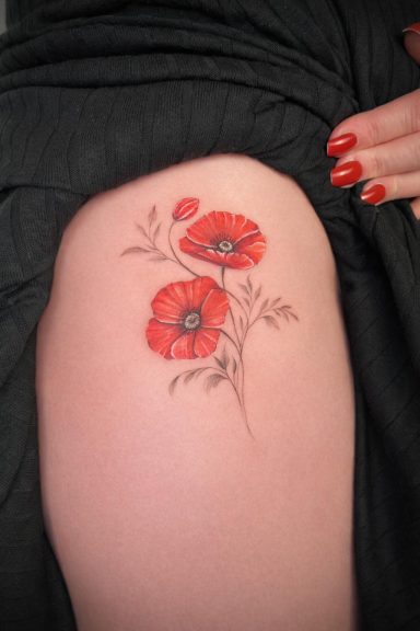Realistic poppy flower tattoo on the thigh in vibrant red tones by Lena Luna Tattoo in Letchworth